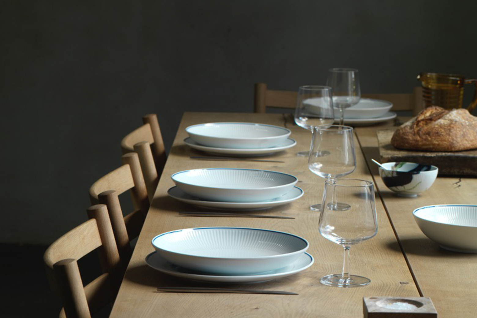 A nordic inspired dinner table set with the ekegang Blueline dinner plates and deep plates